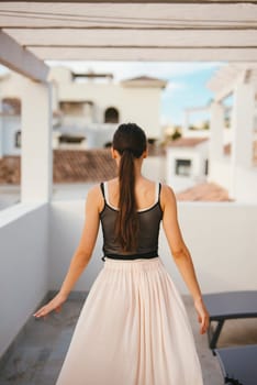 A graceful and elegant woman wearing a flowing skirt is enjoying the beautiful outdoors in a serene setting