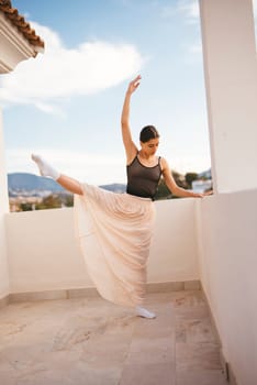 A skilled dancer strikes an elegant pose on a charming balcony, showcasing a beautiful dance in nature