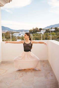A dancer poses on a scenic balcony, showcasing beautiful mountain views and embodying elegance and poise
