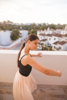A graceful dancer striking an elegant pose atop a scenic rooftop, framed by a stunning sunset backdrop