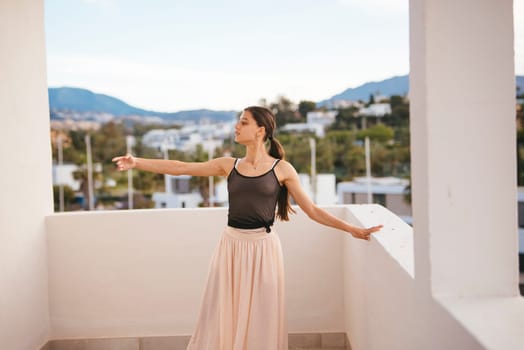 A graceful young woman poses elegantly with majestic mountains behind her, showcasing her beauty to the world
