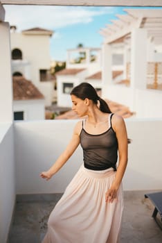 A joyful woman revels in a carefree moment, dancing freely on her balcony, embraced by stunning architecture
