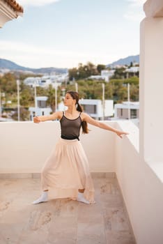 A skilled dancer poses gracefully outdoors, displaying elegance and beauty against a stunning scenic background