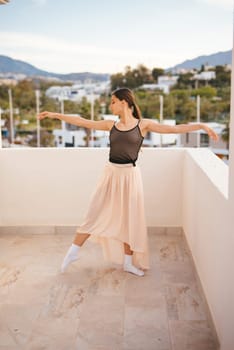 A talented dancer performs ballet beautifully and gracefully against a breathtakingly stunning mountain backdrop