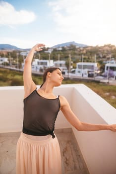 A talented dancer strikes a beautiful pose on a balcony, blending elegance with the natural beauty around her