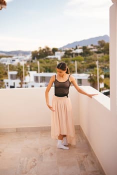 A graceful woman dressed in an elegant skirt enjoys a beautiful and captivating view from a modern balcony