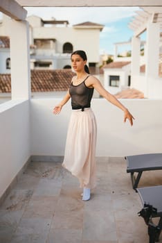 A graceful dancer elegantly poses in a sheer top and a flowing skirt, capturing a stunning moment of beauty and grace