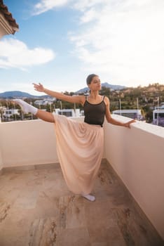 A graceful and skilled dancer strikes an elegant pose on a balcony that offers stunning and breathtaking views