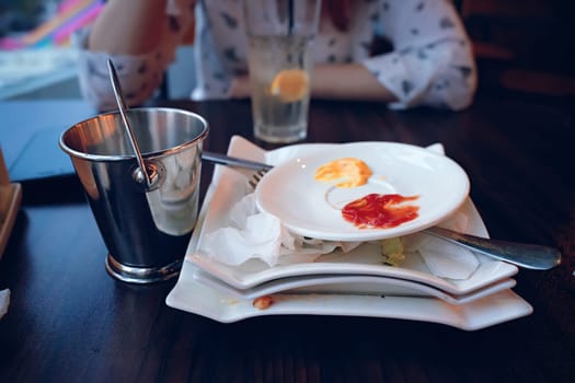 The setting beautifully showcases a partially finished meal featuring various dips and a refreshing drink