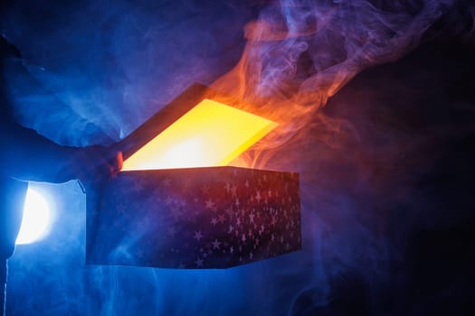 magic surprise box on dark background with smoke, discount and sale concept, magic gift