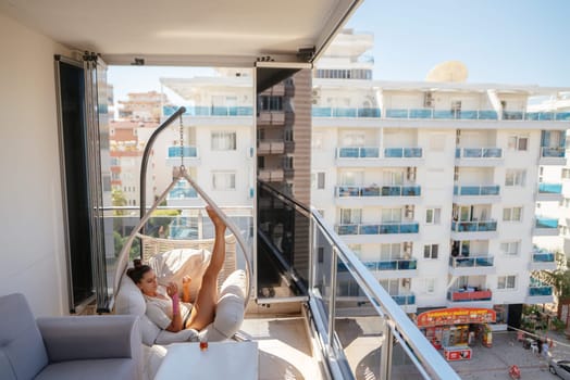 A beautifully serene moment spent on a stylishly decorated balcony showcasing vibrant views of the city