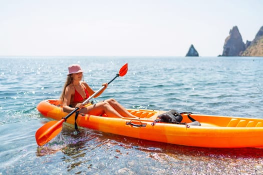 Kayak sea woman. Happy attractive woman with long hair in red swimsuit, swimming on kayak. Summer holiday vacation and travel concept