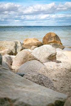 beach with rochs in denmark trelde naes at the kattegat water