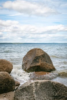 beach with rochs in denmark trelde naes at the kattegat water
