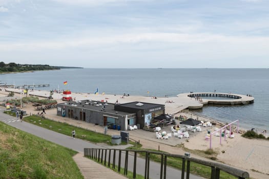 Fredericia, Jutland, Denmark, July 25, 2024 - Sandy beach at the city coastline with people enjoy the summer and sun