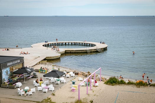 Fredericia, Jutland, Denmark, July 25, 2024 - Sandy beach at the city coastline with people enjoy the summer and sun