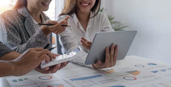 Business People Meeting using laptop computer,calculator,notebook,stock market chart paper for analysis Plans to improve quality next month. Conference Discussion Corporate Concept.