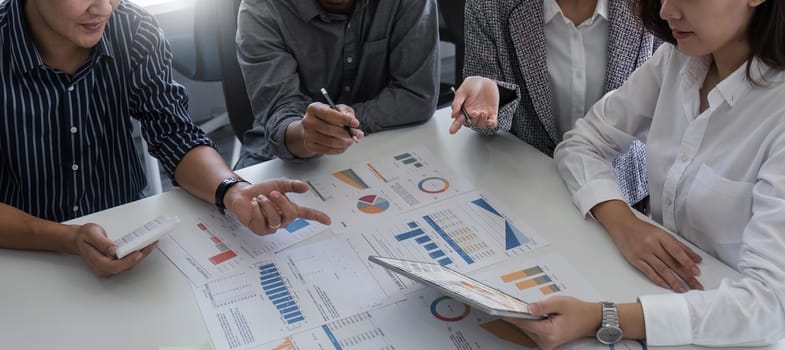 Business People Meeting using laptop computer,calculator,notebook,stock market chart paper for analysis Plans to improve quality next month. Conference Discussion Corporate Concept.