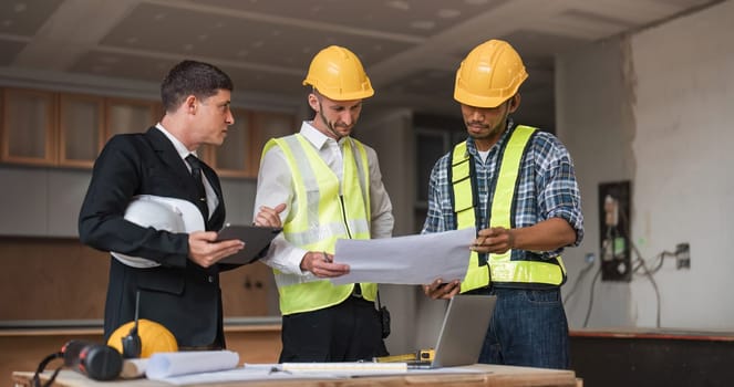 Diverse Team of Specialists Use Laptop on Construction Site. Real Estate Building Project with Engineer Investor and Businessman Checking Area, working on Civil Engineering, Discussing Strategy Plan.