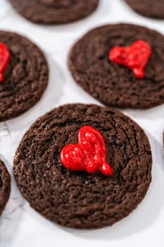 Freshly baked chocolate cookies with chocolate hearts for Valentine's Day.