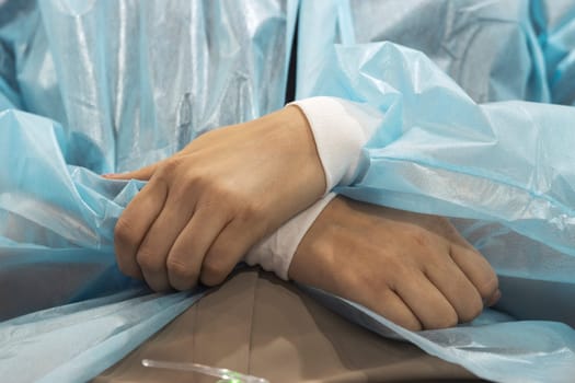 girl folded her hands waiting for a medical procedure , close-up