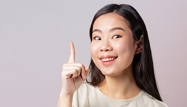 Portrait of young beautiful Asian lady smiling with cheerful expression, shows something amazing at blank space banner background poster wallpaper. AI Generative.