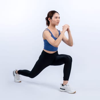 Young attractive asian woman in sportswear stretching before fitness exercise routine. Healthy body care workout with athletic woman warming up on studio shot isolated background. Vigorous