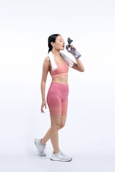 Athletic and sporty asian woman resting and drink water after intensive cardio workout training. Healthy exercising and fit body care lifestyle pursuit in studio shot isolated background. Vigorous