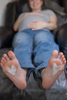 Pregnant woman on a hardware pedicure procedure in a beauty salon