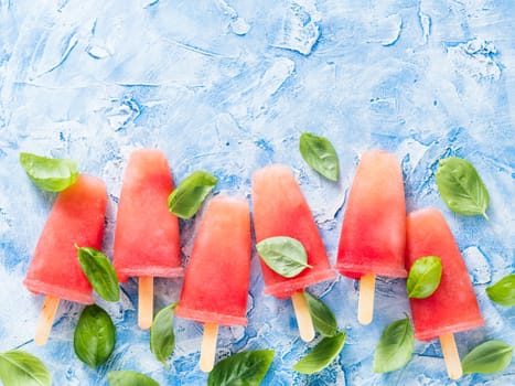 Top view of watermelon and basil popsicles with copy space. Popsicles recipe idea.
