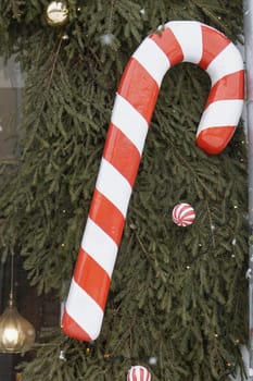 Christmas trees decorated with red balloons in front of the cafe entrance. Street New Year decorations.
