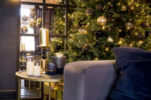Christmas interior with a beautiful Christmas tree, sofa, light bulbs and dark background