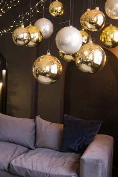 Christmas interior with a beautiful sofa, light bulbs and dark background