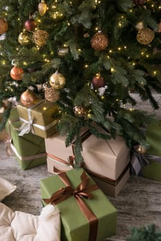 Bronze balls on the Christmas tree close-up. Christmas tree design decorations. The concept of celebrating New Year and Christmas