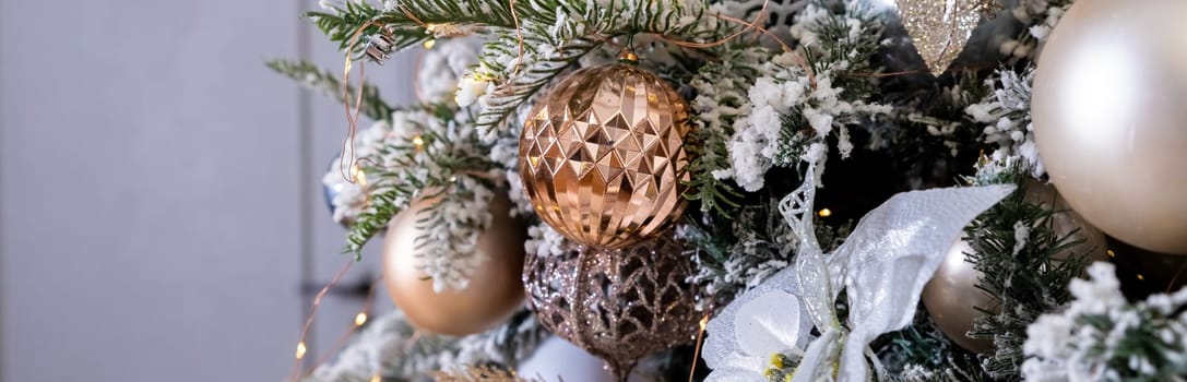 Golden textured ornament on the Christmas tree with bokeh lights background. Christmas and New Year concept