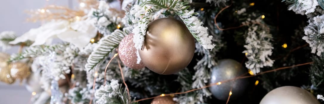 Golden textured ornament on the Christmas tree with bokeh lights background. Christmas and New Year concept