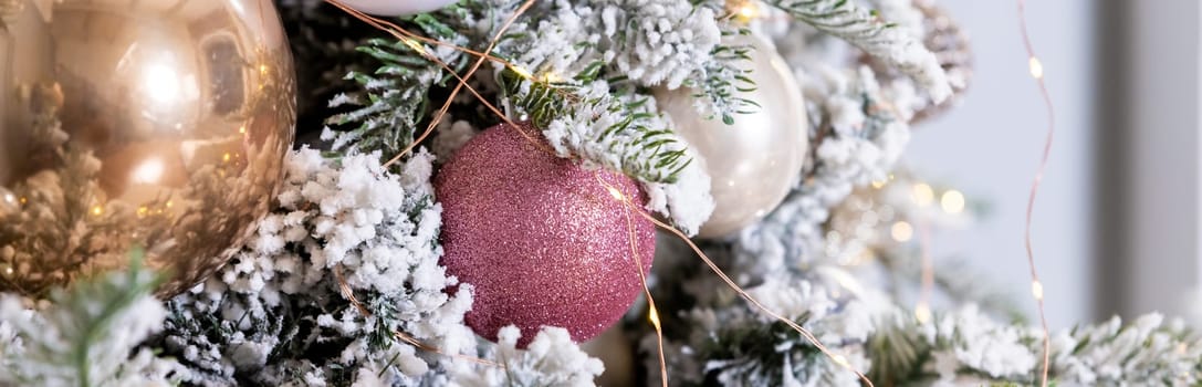 Golden textured ornament on the Christmas tree with bokeh lights background. Christmas and New Year concept