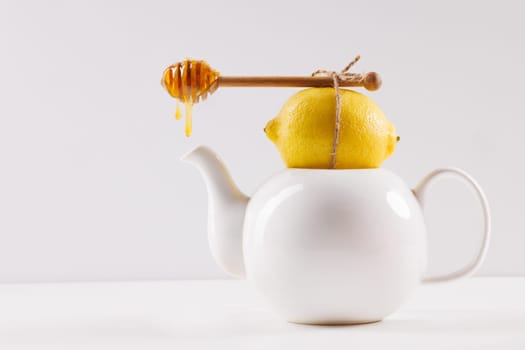 honey spoon with spilled honey on white background, top view, honey benefits concept