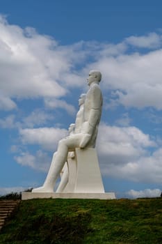 White Men statues, Esbjerg, Denmark. Four white men sitting looking at the sea near Esbjerg, Denmark. They are each 9 meters tall and made of white concrete.
