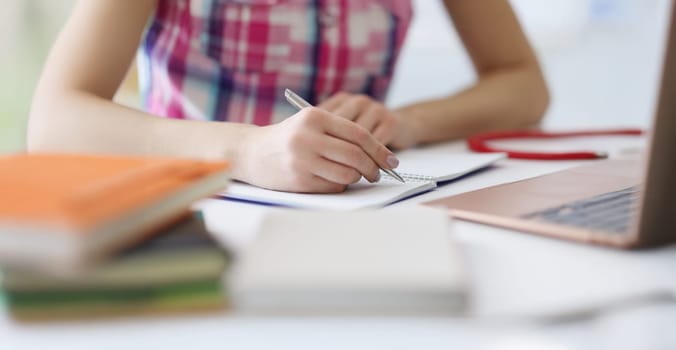 Close-up of person writing down ideas in diary, making notes for future, planning day. Man use for writing silver pen. Journal, creativity, writer concept
