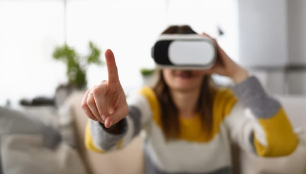 Close-up of womans finger trying to touch invisible things wearing virtual reality glasses. Female explore new world in device. Technology, pastime concept