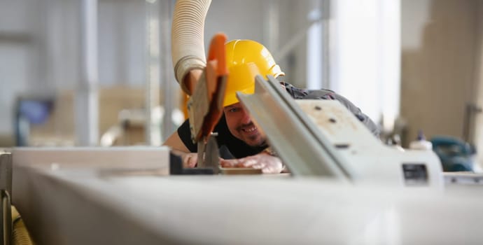 Close-up of qualified male worker using electric saw equipment for work with wood. Handyman on workplace, diy inspiration. Fix, renovation, repair concept