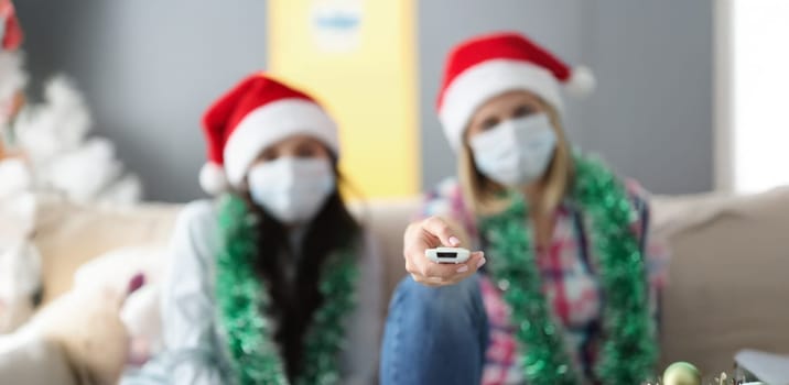 Close-up of female hold remote control tool, switch to next year, change circumstances. Control life, take decision, desire for change, christmas concept