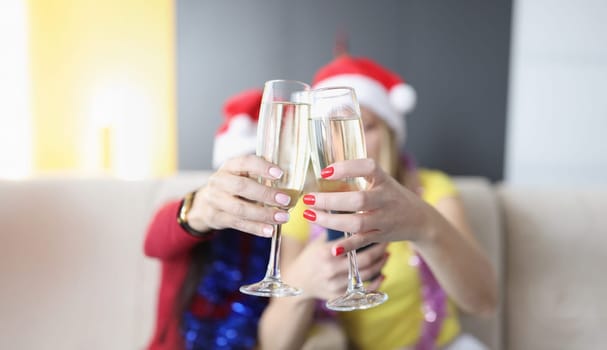 Portrait of women hold champagne drinks, glass filled with alcohol, raise toast for new year coming. Friends celebrate holiday together. Christmas concept