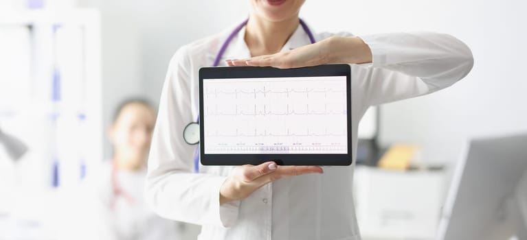 Close-up of doctor showing digital tablet screen with heart cardiogram result. Examination of cardiovascular system. Medicine, cardiology, health concept