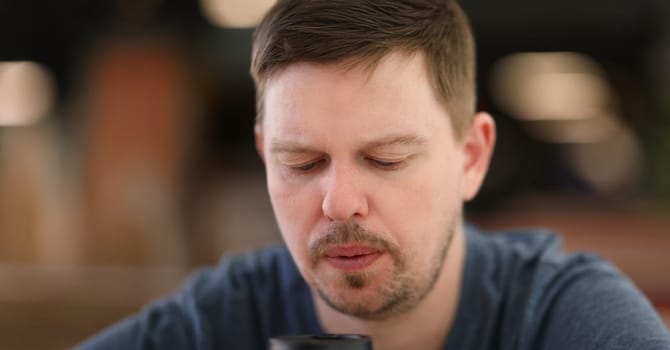Portrait of sad and overwhelmed with something bearded middle aged person looking down. Upset and sorrow unshaven male face . Thoughtful, pensive concept