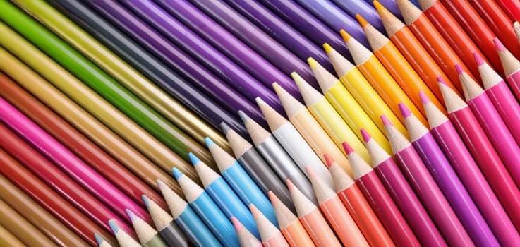 Top view of big assortment of colourful pencils placed over each other. Sharp tips of crayons, ready to paint, bright palette. Hobby, creativity concept