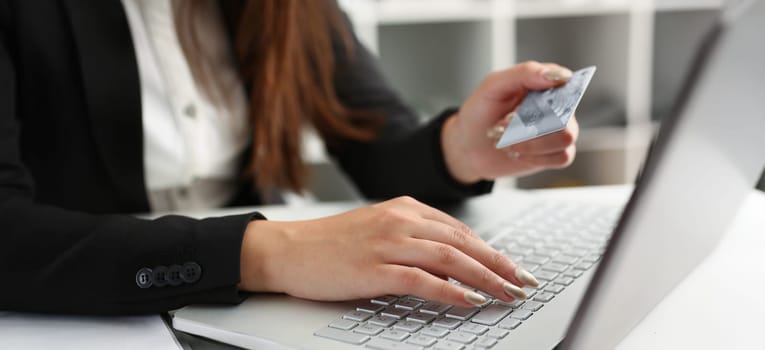 Close-up of woman press knobs on keyboard, pay online with credit card, remote shopping on laptop. Online shopping, technology, contactless payment concept