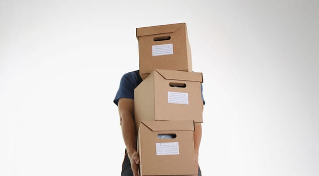 Close-up of postman carry bunch with cardboard packages for further delivery. Courier work for big corporation, place for address. Delivery service concept