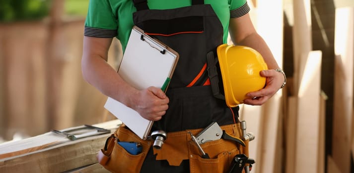 Close-up of handyman with tool belt and construction instruments male worker. Diy inspiration, builder on construction site. Renovation, project concept